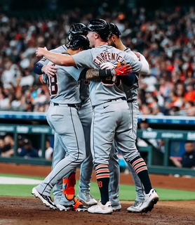 Several Tigers players embracing in a hug